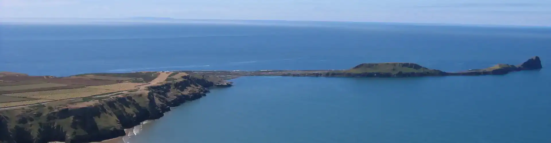 Worm's Head, Gower. Taken while flying a paraglider over Rhossili Down. Photo: Charles C