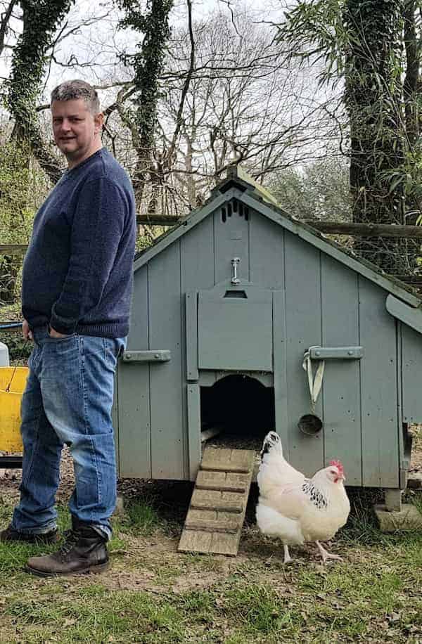 Andrew at feeding time with one of the chickens