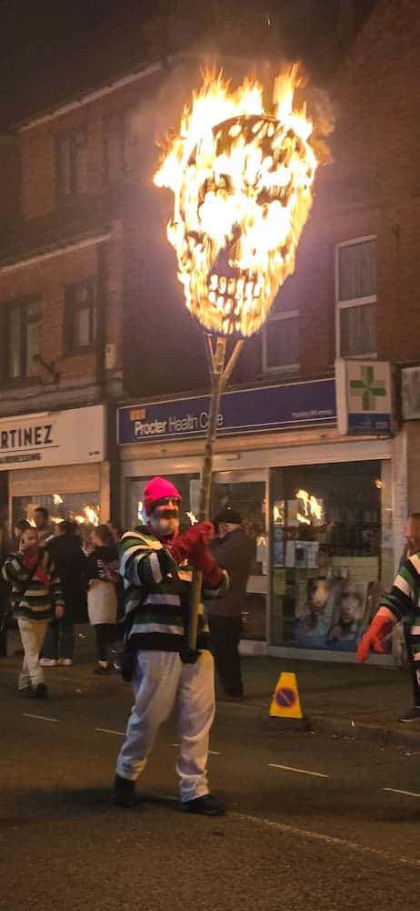 Photo of bonfire society member holding a burning skull