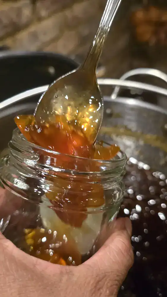 Spooning the warm marmalade into the sterilised jars is a sticky job, but other than labelling, that's about job done!